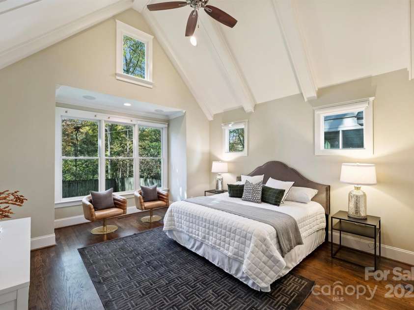 3304 Josephine Court, Charlotte, NC 28205.  MLS# CAR4319912, YatesRealty ID 48912. At day's end retire to the main floor Primary Bedroom with coffered cathedral ceiling, box bay triple window, recessed lighting and speakers, lavish bath, and custom closet.