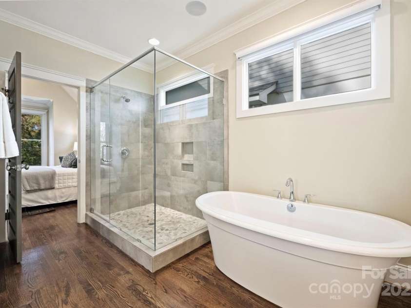 3304 Josephine Court, Charlotte, NC 28205.  MLS# CAR4319912, YatesRealty ID 48912. The splendid Primary bath features a freestanding soaking tub, large rimless shower with small river rock floor, linen closet, and private water closet.