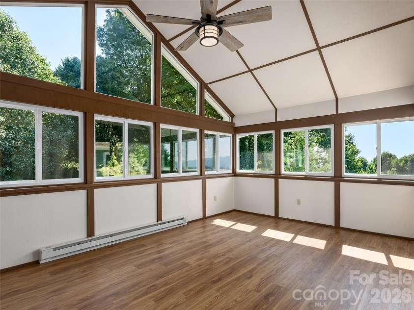 288 Roberts Drive, Laurel Park, NC 28739.  MLS# CAR4420800, YatesRealty ID 48914. Sunroom with mountain views and access to large deck