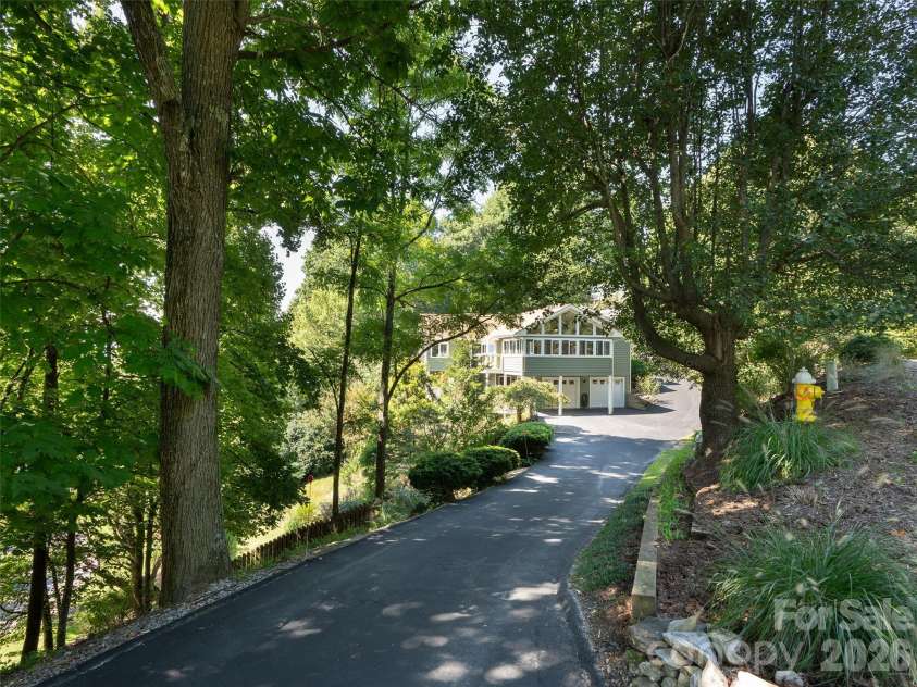 288 Roberts Drive, Laurel Park, NC 28739.  MLS# CAR4420800, YatesRealty ID 48914. Tree-lined driveway