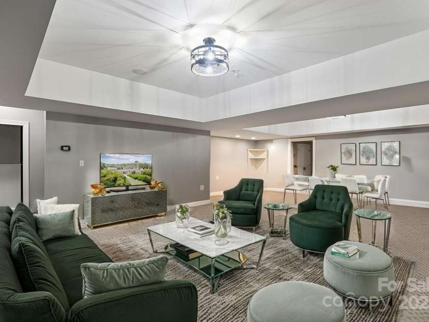 128 Archbell Point Lane, Mooresville, NC 28117.  MLS# CAR4192948, YatesRealty ID 4892. Basement Living Area with staged furniture