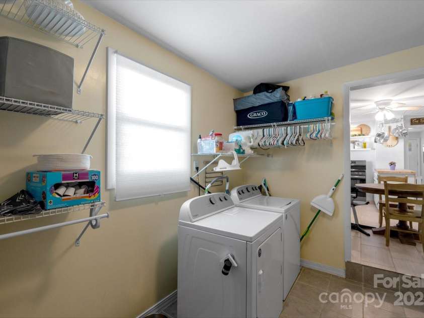 21 Sellers Road, Clyde, NC 28721.  MLS# CAR4228545, YatesRealty ID 4895. Laundry area right off the kitchen has loads of storage