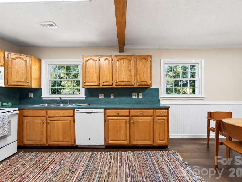 2 Independence Boulevard, Asheville, NC 28805.  MLS# CAR4419918, YatesRealty ID 48988. New laminate flooring in the kitchen (NOTE: ONE CABINET DOOR IS MISSING AND IN THE PROCESS OF BEING REPLACED...PHOTO EDITED TO INCLUDE DOOR)