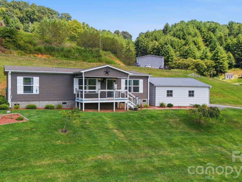 582 John Henry Road, Burnsville, NC 28714.  MLS# CAR4421454, YatesRealty ID 49014. Front exterior and maintained grounds