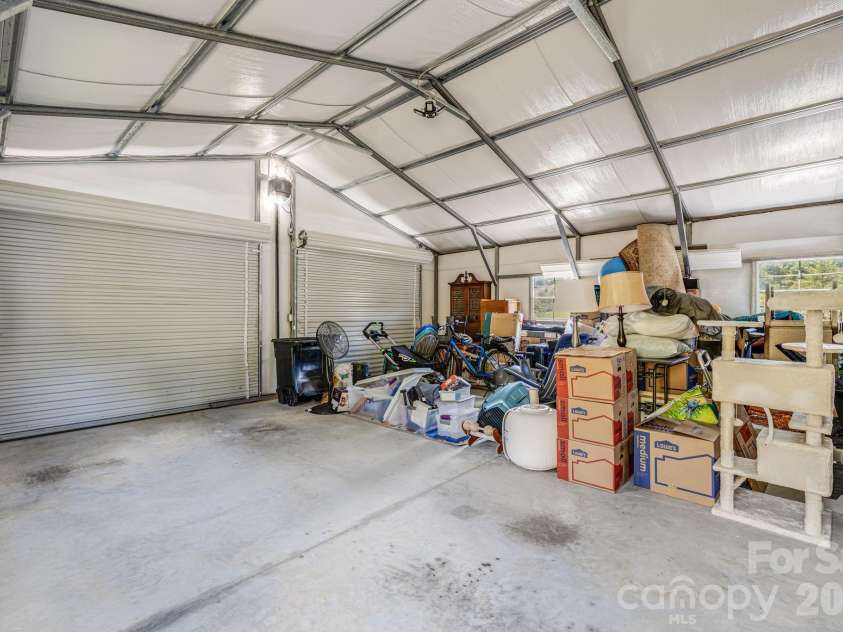 582 John Henry Road, Burnsville, NC 28714.  MLS# CAR4421454, YatesRealty ID 49014. Garage workspace and storage