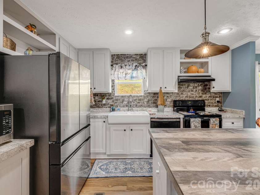 582 John Henry Road, Burnsville, NC 28714.  MLS# CAR4421454, YatesRealty ID 49014. Kitchen island and workspace