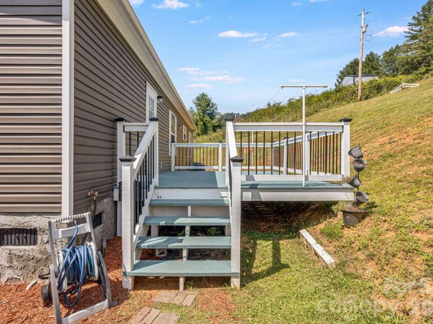 582 John Henry Road, Burnsville, NC 28714.  MLS# CAR4421454, YatesRealty ID 49014. Rear deck and backyard