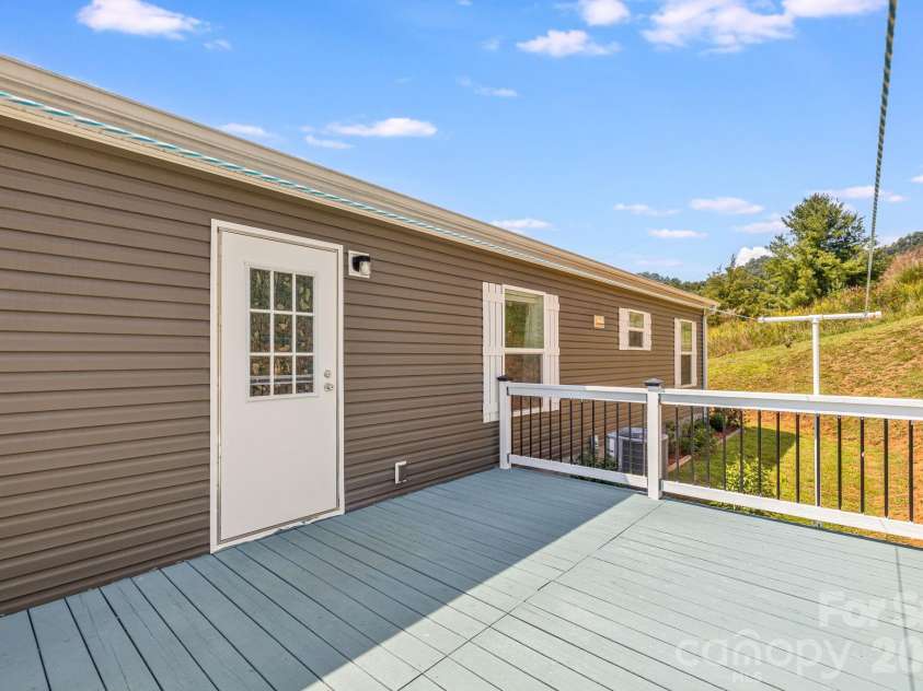 582 John Henry Road, Burnsville, NC 28714.  MLS# CAR4421454, YatesRealty ID 49014. Rear deck and exterior access