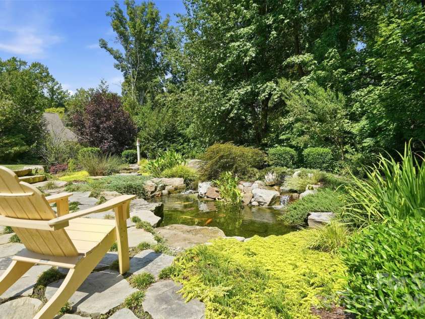 1206 Delaney Drive, Weddington, NC 28104.  MLS# CAR4421166, YatesRealty ID 49098. Backyard featuring Water Feature w/ Koi pond & wooded privacy