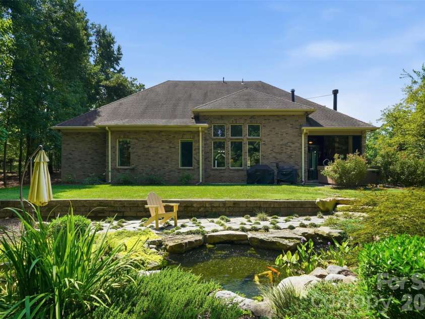 1206 Delaney Drive, Weddington, NC 28104.  MLS# CAR4421166, YatesRealty ID 49098. Backyard featuring Water Feature w/ Koi pond & wooded privacy