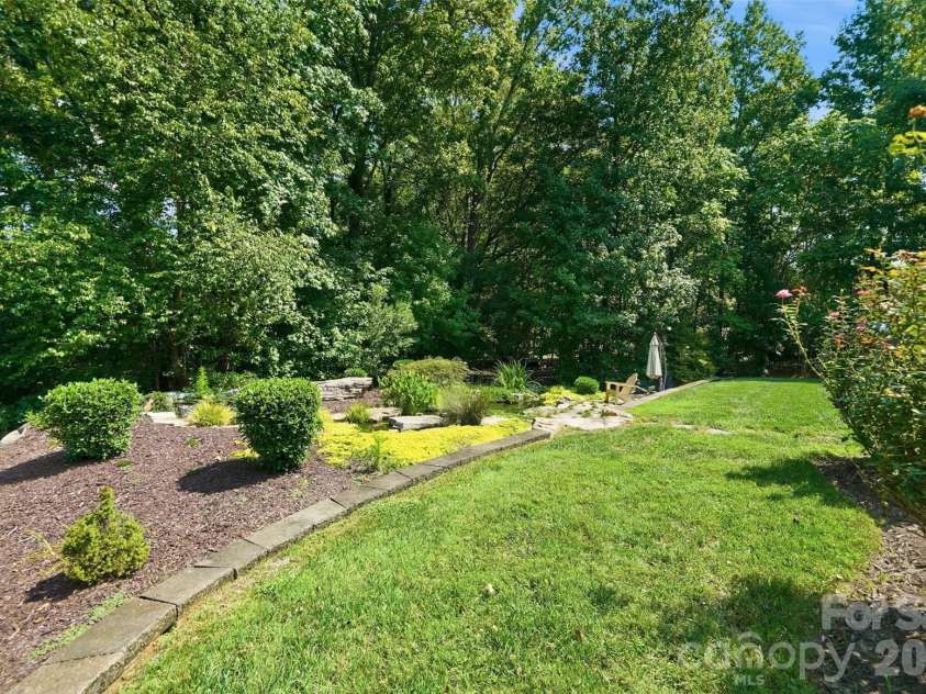 1206 Delaney Drive, Weddington, NC 28104.  MLS# CAR4421166, YatesRealty ID 49098. Backyard featuring Water Feature w/ Koi pond & wooded privacy