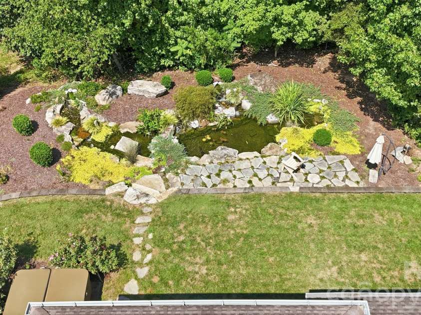 1206 Delaney Drive, Weddington, NC 28104.  MLS# CAR4421166, YatesRealty ID 49098. Backyard featuring Water Feature w/ Koi pond & wooded privacy