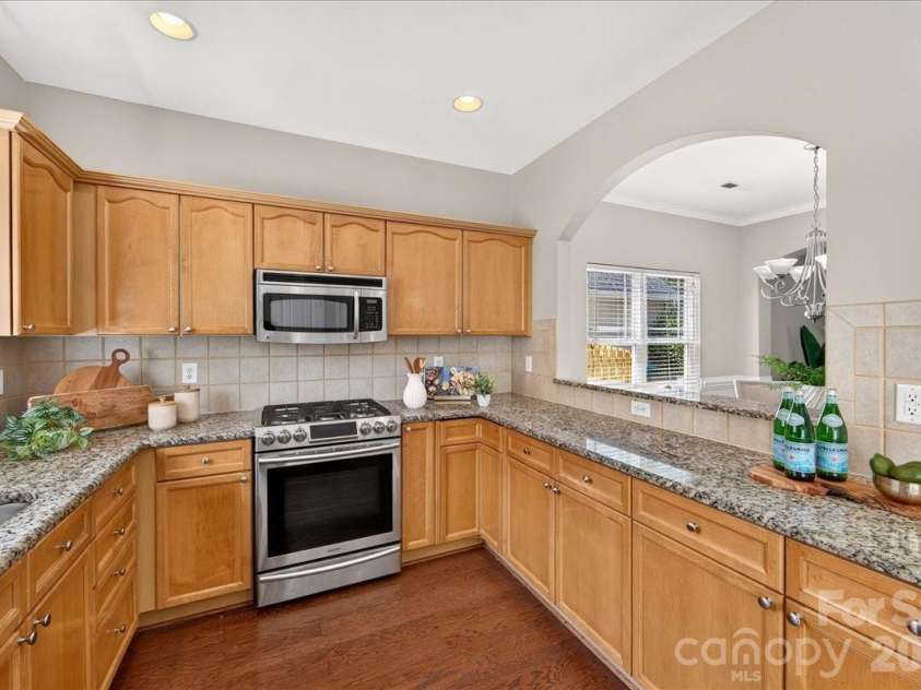 9026 Crusaders Court, Matthews, NC 28105.  MLS# CAR4420940, YatesRealty ID 49102. Breakfast bar for easy entertaining!