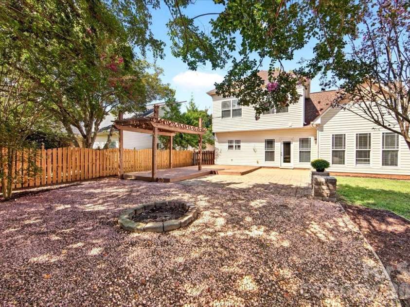 9026 Crusaders Court, Matthews, NC 28105.  MLS# CAR4420940, YatesRealty ID 49102. Gravel firepit area!