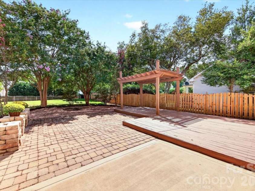 9026 Crusaders Court, Matthews, NC 28105.  MLS# CAR4420940, YatesRealty ID 49102. Paver patio, deck, and pergola (both recently stained)!