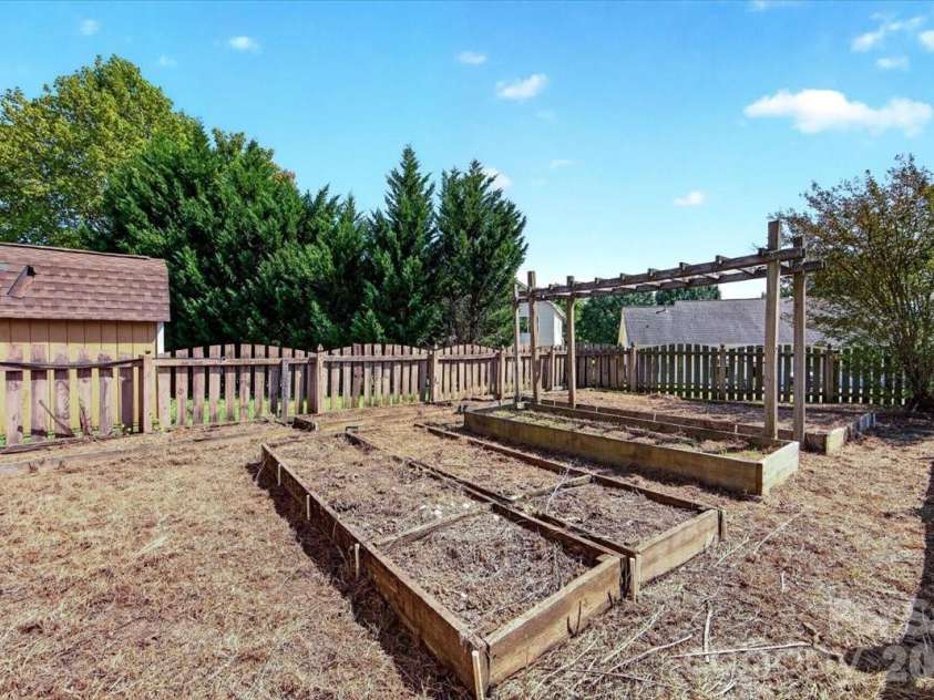 9026 Crusaders Court, Matthews, NC 28105.  MLS# CAR4420940, YatesRealty ID 49102. Raised garden area!