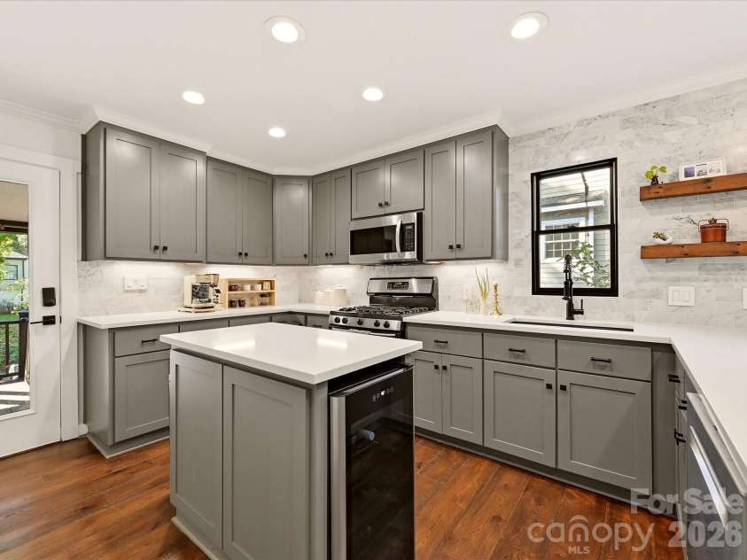 21624 Rio Oro Drive, Cornelius, NC 28031.  MLS# CAR4419384, YatesRealty ID 49127. Kitchen showing island with wine fridge