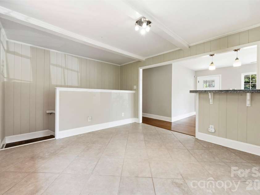 6506 Candlewood Drive, Charlotte, NC 28210.  MLS# CAR4401762, YatesRealty ID 49207. Current owners had their main DR table and chairs here. The table doubled as the buffet for Sunday brunch and birthday celebrations. You can also see the view of stairs going down to basement level. There is a beauti