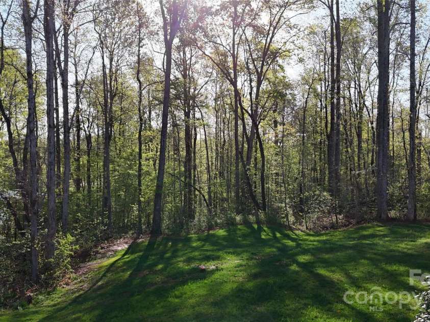 472 Bellingshire Drive, Mt Ulla, NC 28125.  MLS# CAR4292714, YatesRealty ID 4922. Backyard reaches well into the woods