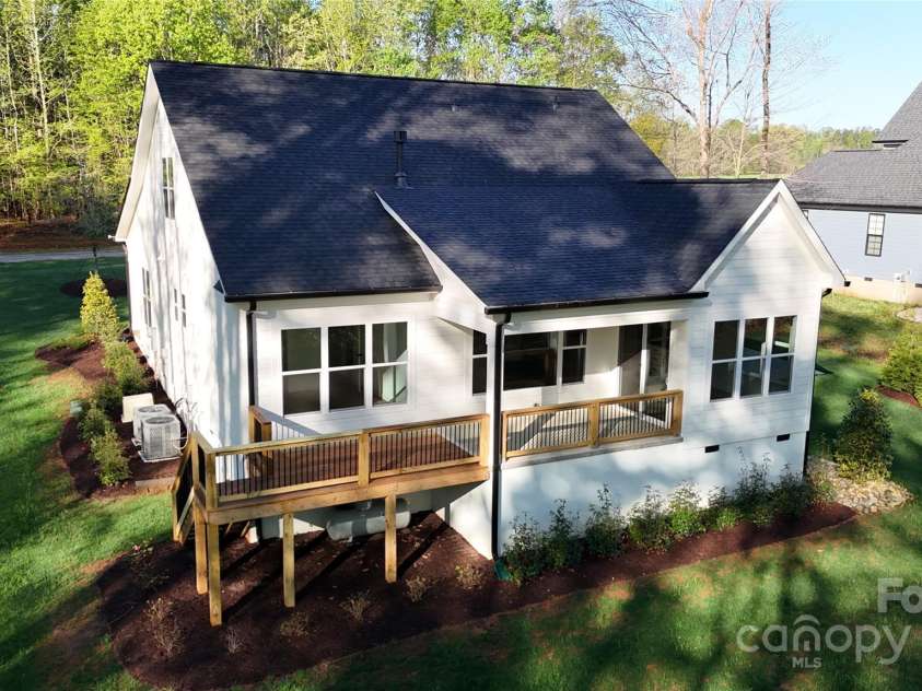 472 Bellingshire Drive, Mt Ulla, NC 28125.  MLS# CAR4292714, YatesRealty ID 4922. Covered porch and deck overlook the wooded backyard