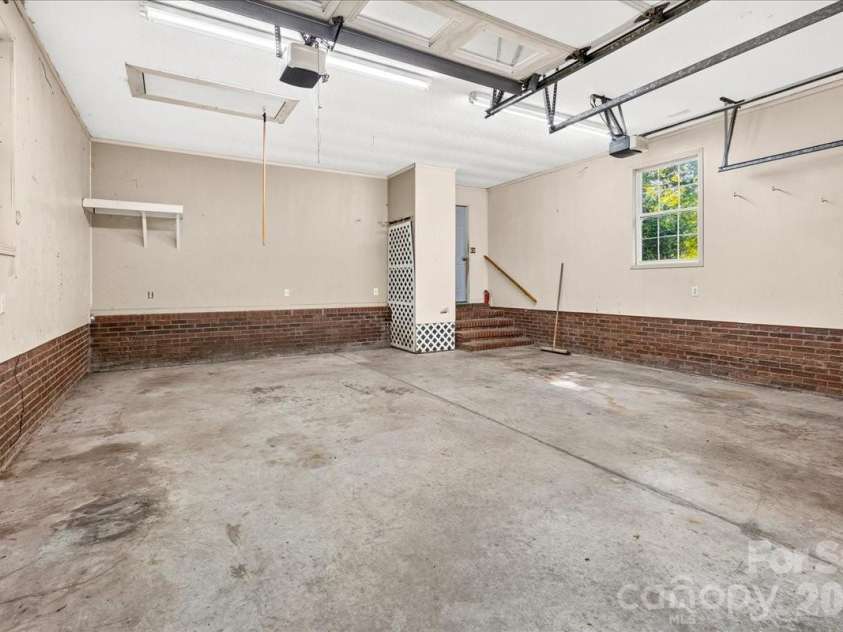 6712 Mexico Road, Concord, NC 28025.  MLS# CAR4400821, YatesRealty ID 49257. Large 2 car garage leading into kitchen area.