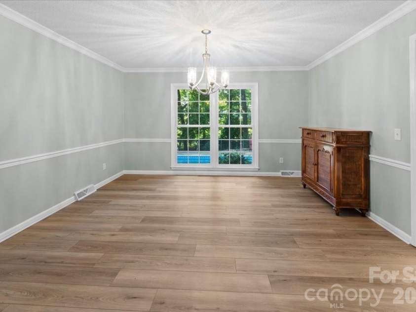 705 Brunson Drive, Albemarle, NC 28001.  MLS# CAR4422232, YatesRealty ID 49272. Large dining room with chair railing.
