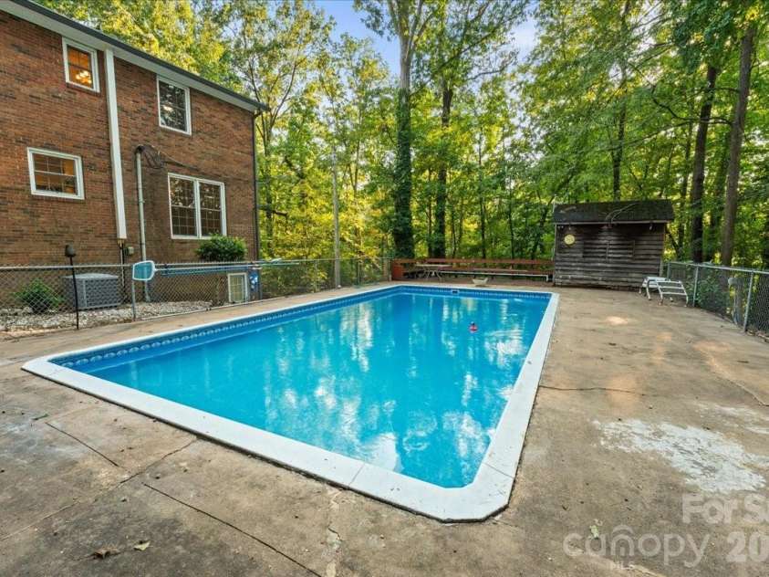 705 Brunson Drive, Albemarle, NC 28001.  MLS# CAR4422232, YatesRealty ID 49272. Large pool with equipment structure.