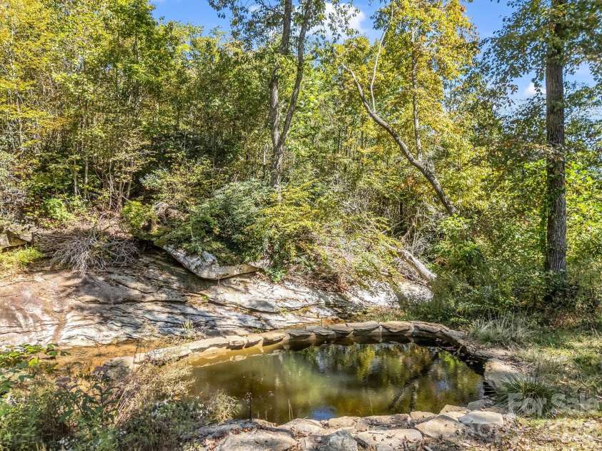 119 Mountain Bluff Trail, Hendersonville, NC 28792.  MLS# CAR4422233, YatesRealty ID 49280. Natural soaking pool, fed from stream