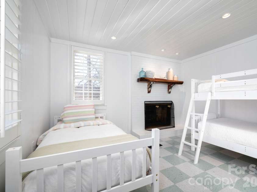 183 Blarney Road, Lake Lure, NC 28746.  MLS# CAR4326369, YatesRealty ID 49285. 4th bedroom has wood burning fireplace and three single beds.
