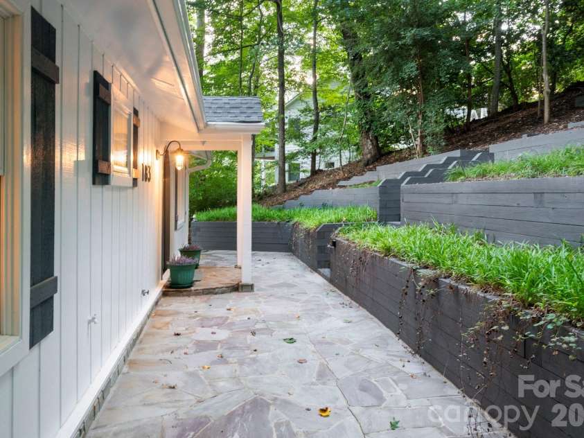 183 Blarney Road, Lake Lure, NC 28746.  MLS# CAR4326369, YatesRealty ID 49285. Front stone patio and charming arched entry.