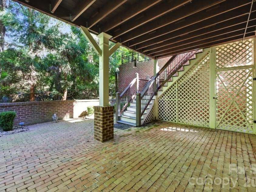 8928 Heydon Hall Circle, Charlotte, NC 28210.  MLS# CAR4297775, YatesRealty ID 49323. Brick paver patio below raised screened in deck.