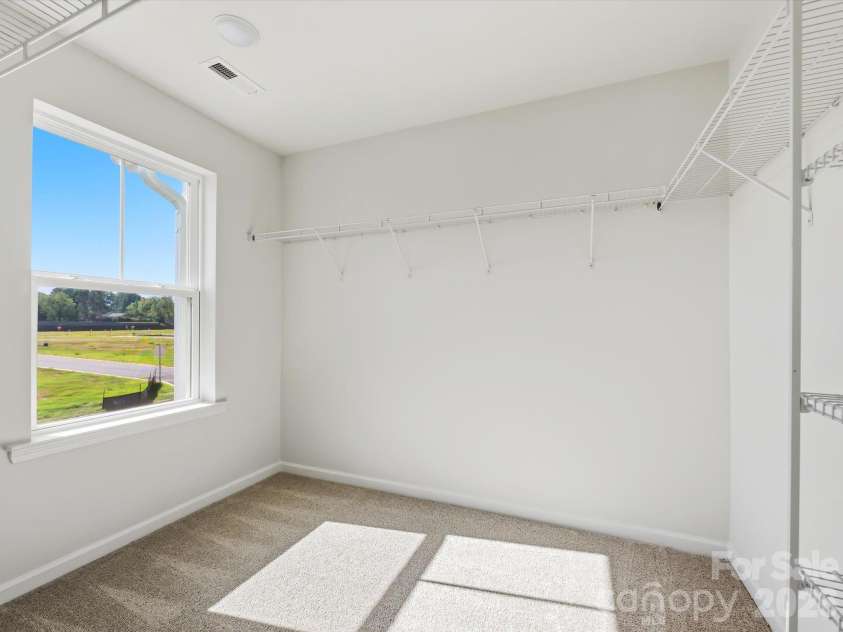6617 Fire Lily Lane, Charlotte, NC 28216.  MLS# CAR4422331, YatesRealty ID 49324. Large Owner's Closet with Window