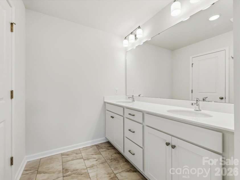6617 Fire Lily Lane, Charlotte, NC 28216.  MLS# CAR4422331, YatesRealty ID 49324. Owner's Bathroom Offering a Dual Sink Vanity