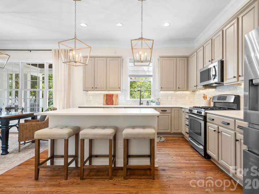8606 Camberly Road, Huntersville, NC 28078.  MLS# CAR4404900, YatesRealty ID 49341. Updated kitchen with painted cabinets, quartz counters and tiled backsplash. Stainless appliances include a gas stove top.