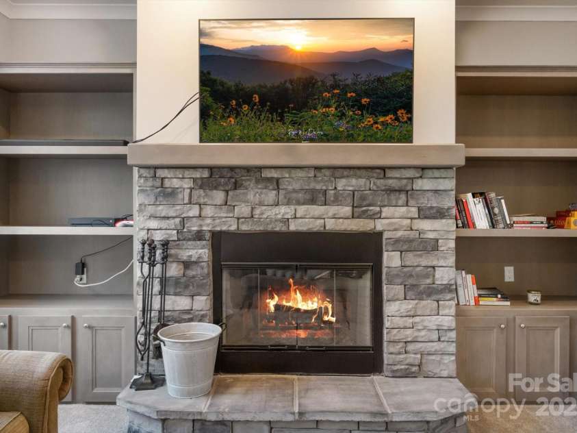 52 Stone Ridge Trail, Mills River, NC 28759.  MLS# CAR4239861, YatesRealty ID 4935. Wood-burning fireplace with a mounted TV in the living room