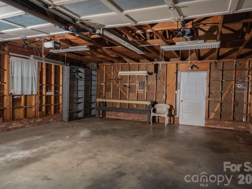 3401 Tracelake Drive, Matthews, NC 28105.  MLS# CAR4417359, YatesRealty ID 49352. Attached garage with small work table.