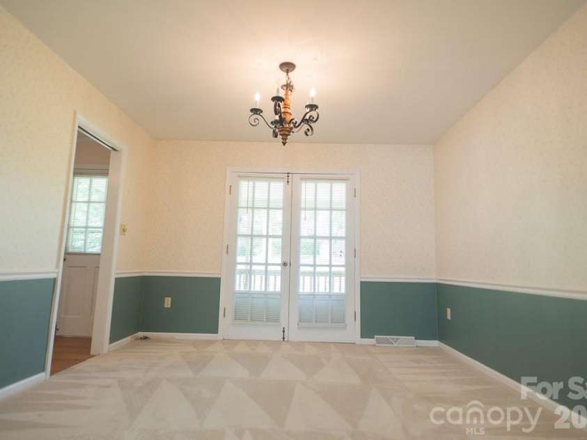 3401 Tracelake Drive, Matthews, NC 28105.  MLS# CAR4417359, YatesRealty ID 49352. Dining Room that open to the deck through the double doors