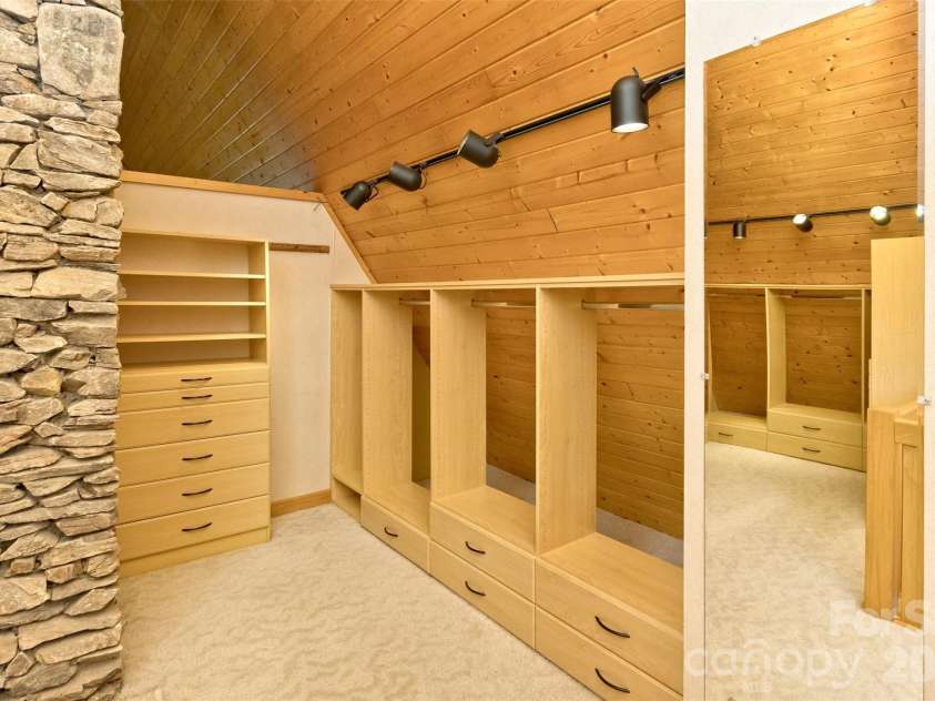 16 Spruce Way, Fairview, NC 28730.  MLS# CAR4421539, YatesRealty ID 49354. The clothing racks were thoughtfully designed with open backs to allow for additional storage for infrequently-used items in the space behind.