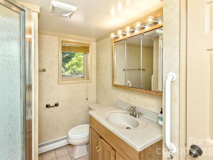16 Spruce Way, Fairview, NC 28730.  MLS# CAR4421539, YatesRealty ID 49354. The guest suite also features a full bathroom with shower.