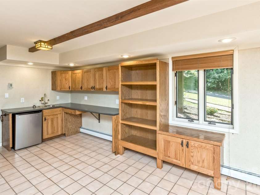 16 Spruce Way, Fairview, NC 28730.  MLS# CAR4421539, YatesRealty ID 49354. The lower-level kitchenette has ample room for small appliances, kitchenware and counter space--making for a quite comfortable separate living space for guests.