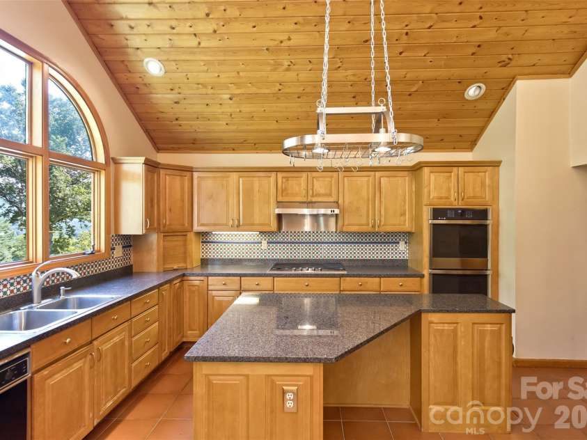 16 Spruce Way, Fairview, NC 28730.  MLS# CAR4421539, YatesRealty ID 49354. The view from the kitchen window will remove any dread of working at the sink!  There could be competition for who gets first dibs on dish duty!