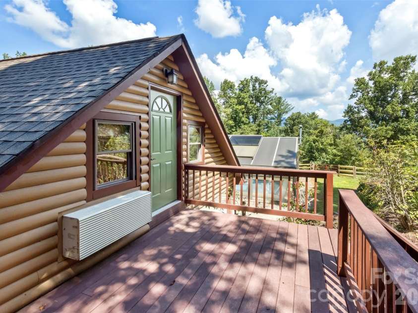 16 Spruce Way, Fairview, NC 28730.  MLS# CAR4421539, YatesRealty ID 49354. This sweet studio not only is delightful inside, but it also has its own private deck for relaxing and catching a bit of fresh air.