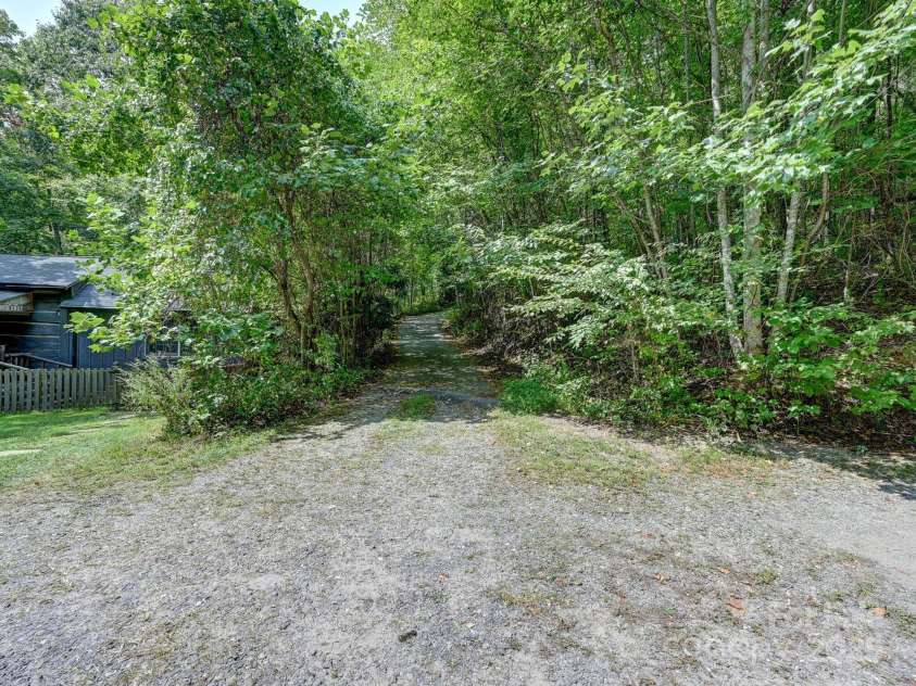 88 Chestnut Forest Road, Fairview, NC 28730.  MLS# CAR4171561, YatesRealty ID 494. Ample parking space and slightly sloping driveway offers easy access to the cabin