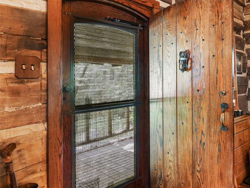 88 Chestnut Forest Road, Fairview, NC 28730.  MLS# CAR4171561, YatesRealty ID 494. Custom-made spline-jointed batten door adds a gorgeous touch to the detail of the home