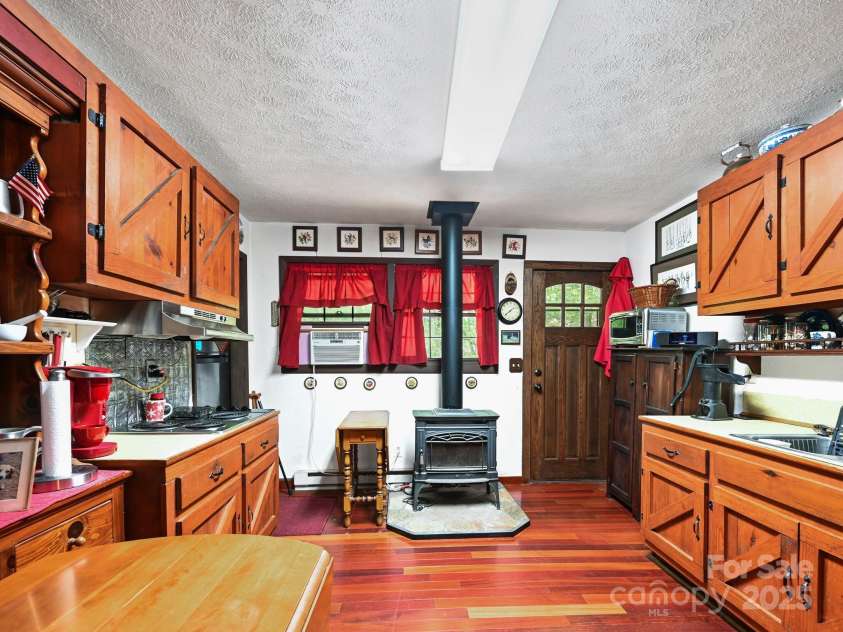 88 Chestnut Forest Road, Fairview, NC 28730.  MLS# CAR4171561, YatesRealty ID 494. Original cabinetry is in excellent condition and contributes to the quaint kitchen