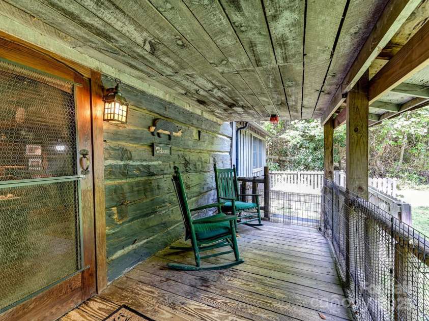 88 Chestnut Forest Road, Fairview, NC 28730.  MLS# CAR4171561, YatesRealty ID 494. Rocking chair porch offers a perfect spot to relax and take in the tranquil surroundings