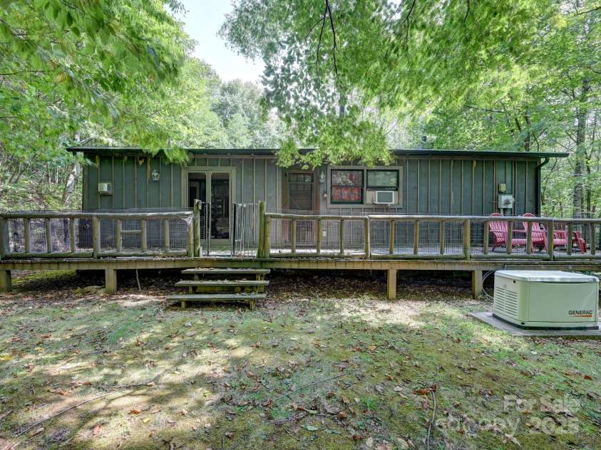 88 Chestnut Forest Road, Fairview, NC 28730.  MLS# CAR4171561, YatesRealty ID 494. Spacious back deck overlooks just one of the exploration trails leading to the year-round creek.