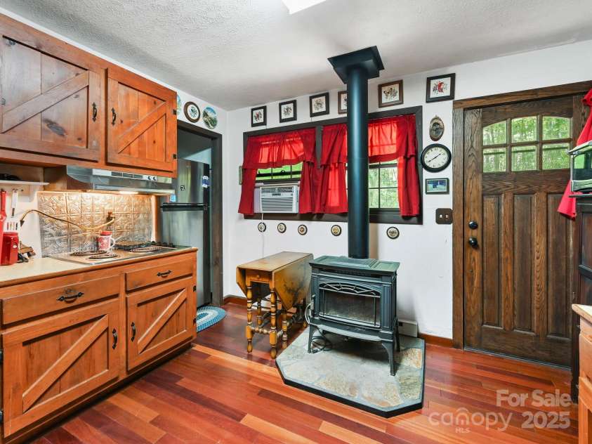 88 Chestnut Forest Road, Fairview, NC 28730.  MLS# CAR4171561, YatesRealty ID 494. Wood burning stove keeps the area warm during cold winter nights