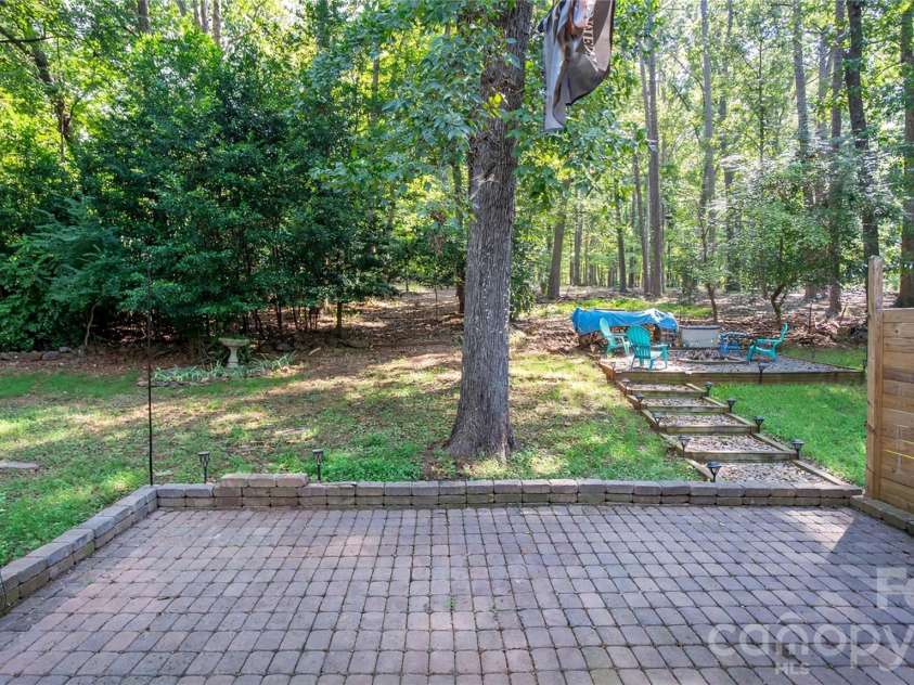 41 Elm Street, Badin, NC 28009.  MLS# CAR4402838, YatesRealty ID 49405. A charming brick patio for entertaining