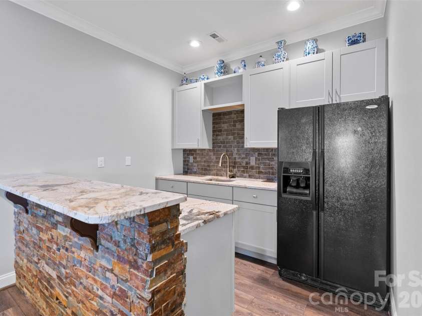 160 Fairway Falls Road, Mills River, NC 28759.  MLS# CAR4353536, YatesRealty ID 4944. Lower level 2nd kitchen area with Granite, tiled backsplash plus refrigerator and wine chiller